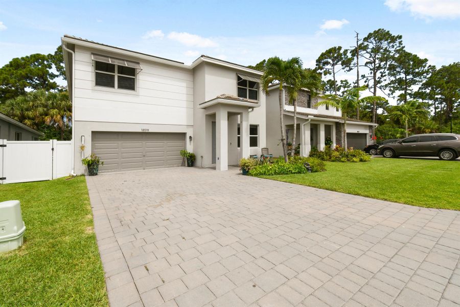 Front exterior of a new home in Reserve at Jupiter, Jupiter, FL, highlighting curb appeal (Image 32).
