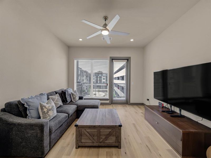 Living room with light wood-style flooring, recessed lighting, and ceiling fan Living room with light wood-style flooring, recessed lighting, and ceiling fan