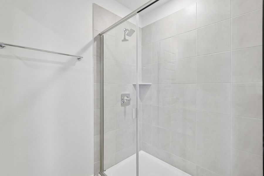 A shower with a glass door.