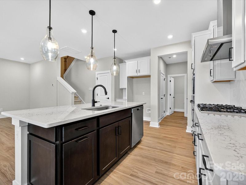 Dual toned cabinets with a dark kitchen island