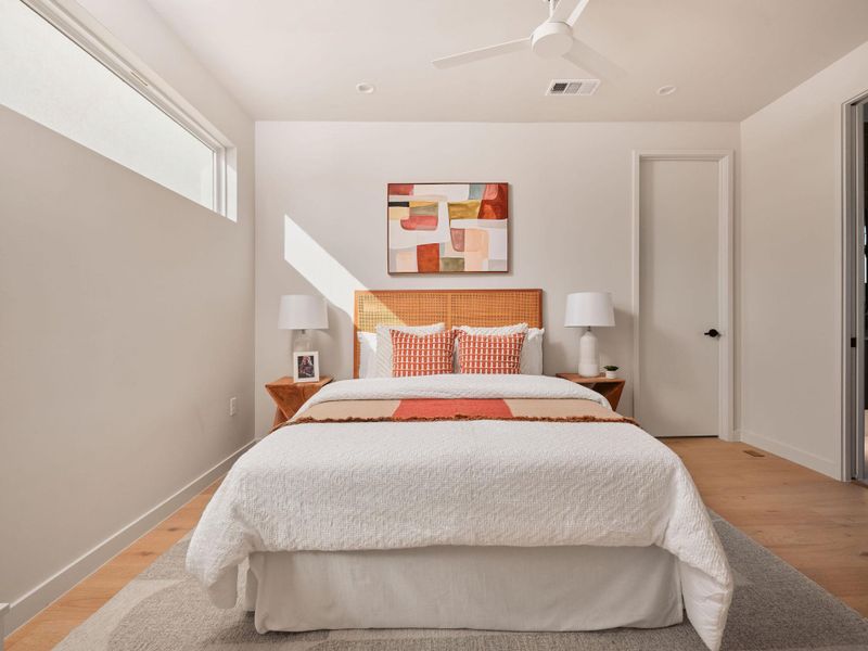 Bedroom with light wood-type flooring and baseboards