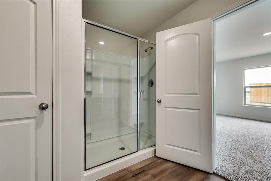 Bathroom with wood-type flooring and walk in shower