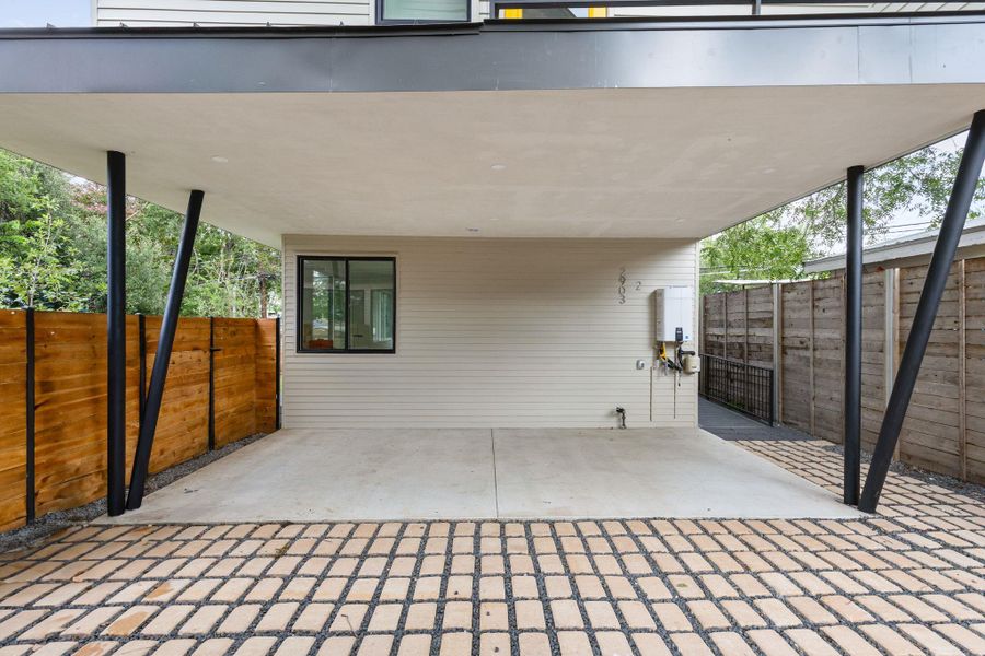 View of patio with a carport and tankless water heater