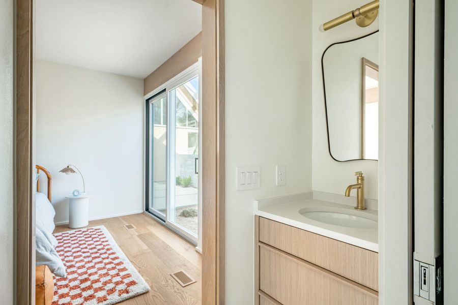 Bathroom with vanity and light wood-type flooring
