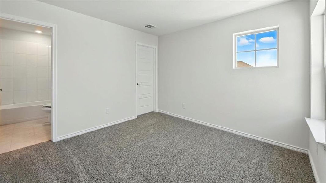 Unfurnished bedroom featuring carpet flooring and baseboards