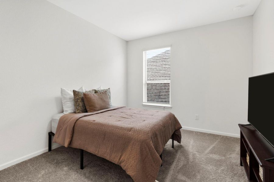 Another secondary bedroom upstairs, showcasing the home's generous floor plan and consistent modern finishes. Another secondary bedroom upstairs, showcasing the home's generous floor plan and consistent modern finishes.