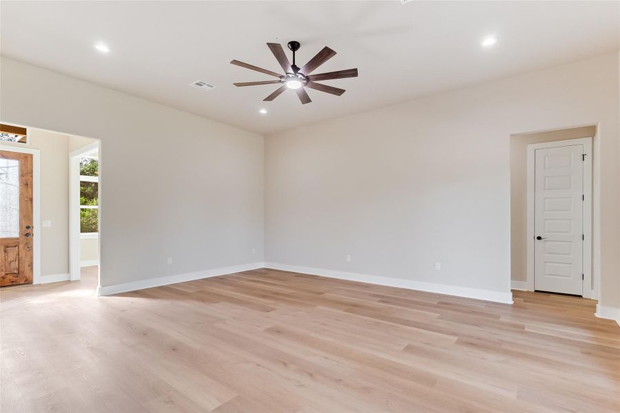 Empty room featuring light wood finished floors, recessed lighting, and ceiling fan Empty room featuring light wood finished floors, recessed lighting, and ceiling fan
