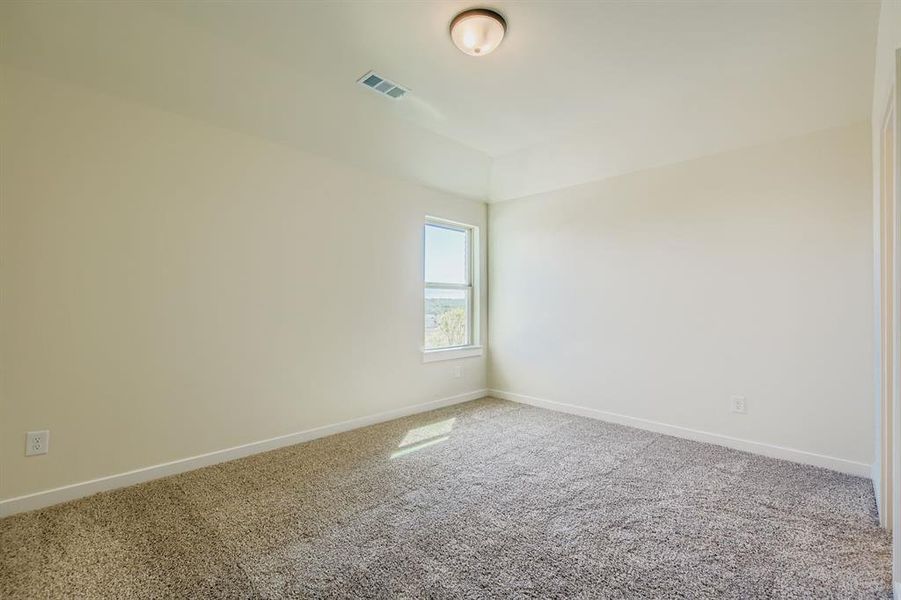 Carpeted empty room with baseboards