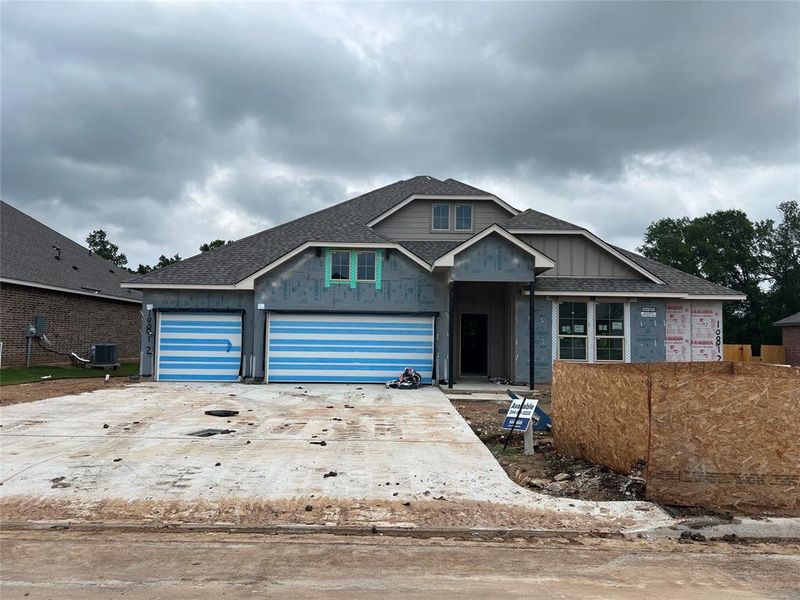 Property under construction featuring central air condition unit, a garage, driveway, board and batten siding, and roof with shingles Property under construction featuring central air condition unit, a garage, driveway, board and batten siding, and roof with shingles