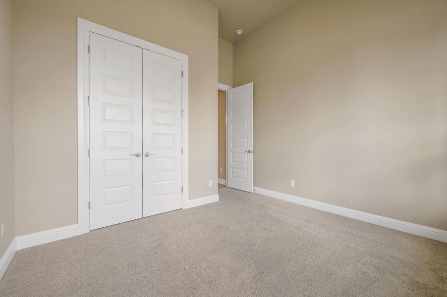 Unfurnished bedroom with carpet floors and a closet