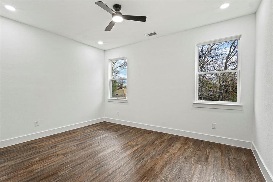 Empty room featuring dark wood finished floors, recessed lighting, and a ceiling fan Empty room featuring dark wood finished floors, recessed lighting, and a ceiling fan