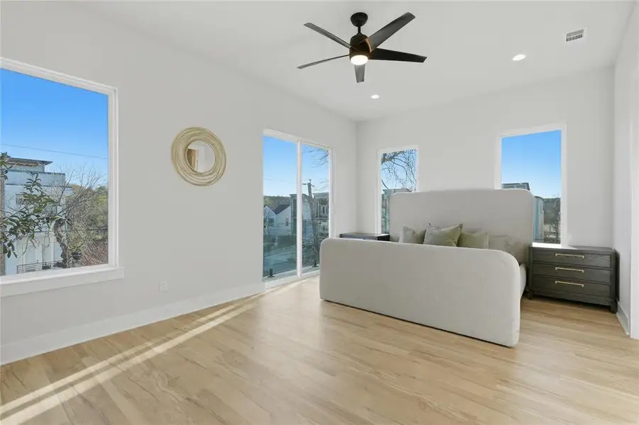 Bedroom with ceiling fan, light wood finished floors, access to exterior, and recessed lighting Bedroom with ceiling fan, light wood finished floors, access to exterior, and recessed lighting