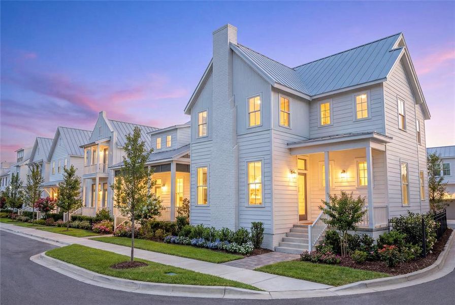 Two-story residence featuring white siding, a metal roof, and a prominent chimney