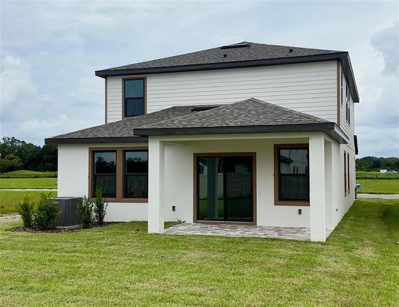 Front exterior of a new home in Grasslands West, Lakeland, FL, highlighting curb appeal (Image 21).