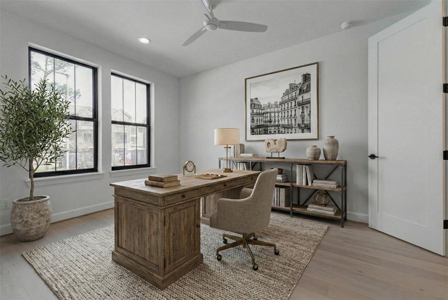 Spacious first-floor bedroom with wide-plank engineered wood floors, oversized black-trimmed windows, and abundant natural light. Ideal as a guest suite, private office, or flex space, this room offers comfort and versatility. Ceiling fan and recessed lighting enhance livability while maintaining the home’s cohesive contemporary aesthetic. This photo has been virtually staged for visual reference.