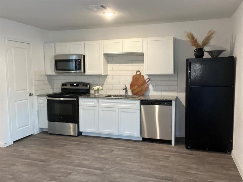 Sleek Galley Kitchen with Cozy Dining Nook