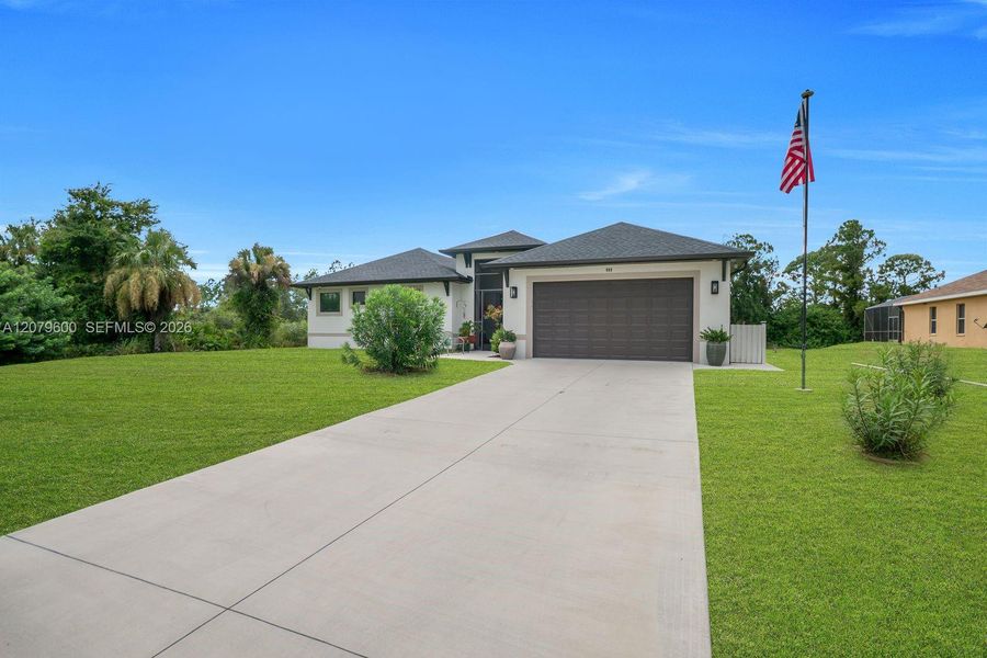 Front exterior of a new home in , Lehigh Acres, FL, highlighting curb appeal (Image 2). Front exterior of a new home in , Lehigh Acres, FL, highlighting curb appeal (Image 2).