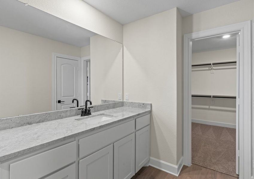 The master bathroom has a large vanity space.