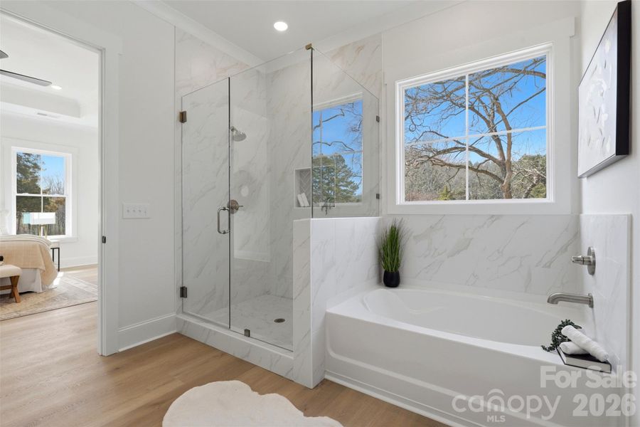 ensuite bathroom- tiled bath, frameless shower, shiplap dual vanities