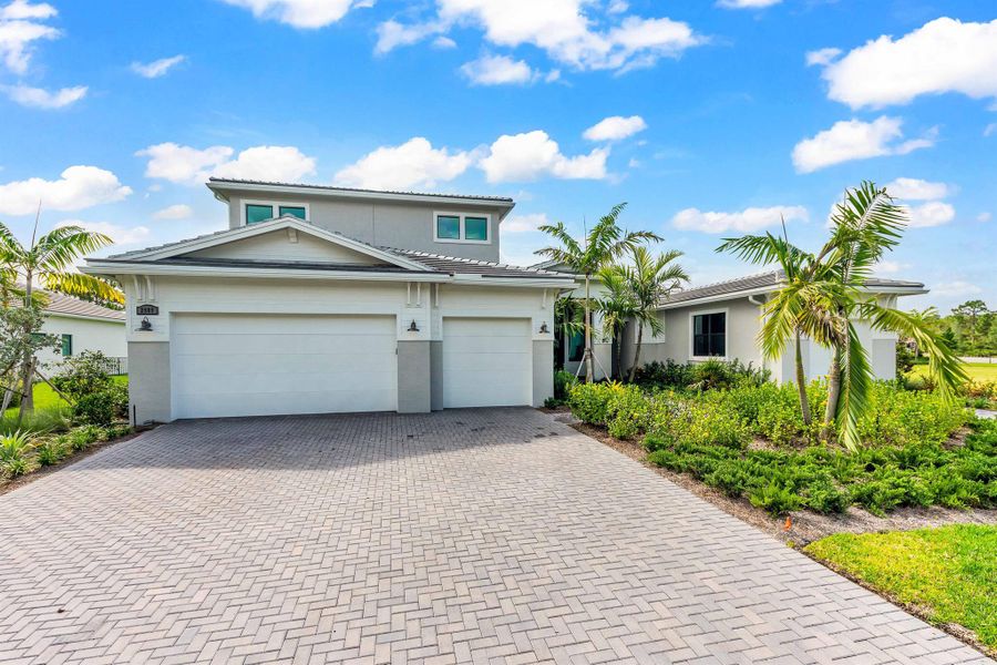Front exterior of a new home in , Palm City, FL, highlighting curb appeal (Image 2). Front exterior of a new home in , Palm City, FL, highlighting curb appeal (Image 2).