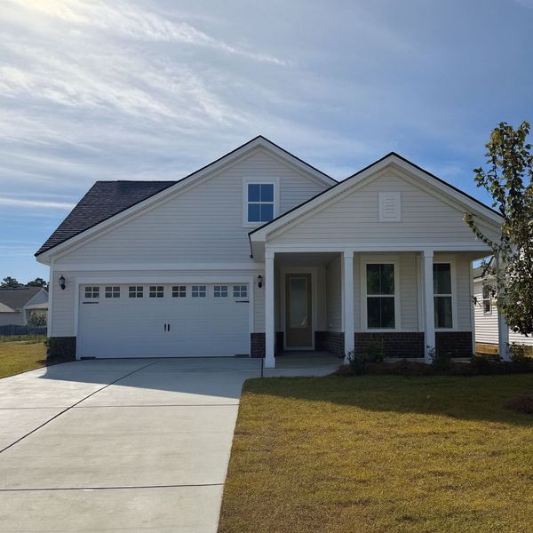 Front exterior of a new home in Crescent Cove, Myrtle Beach, SC, highlighting curb appeal (Image 1). Front exterior of a new home in Crescent Cove, Myrtle Beach, SC, highlighting curb appeal (Image 1).