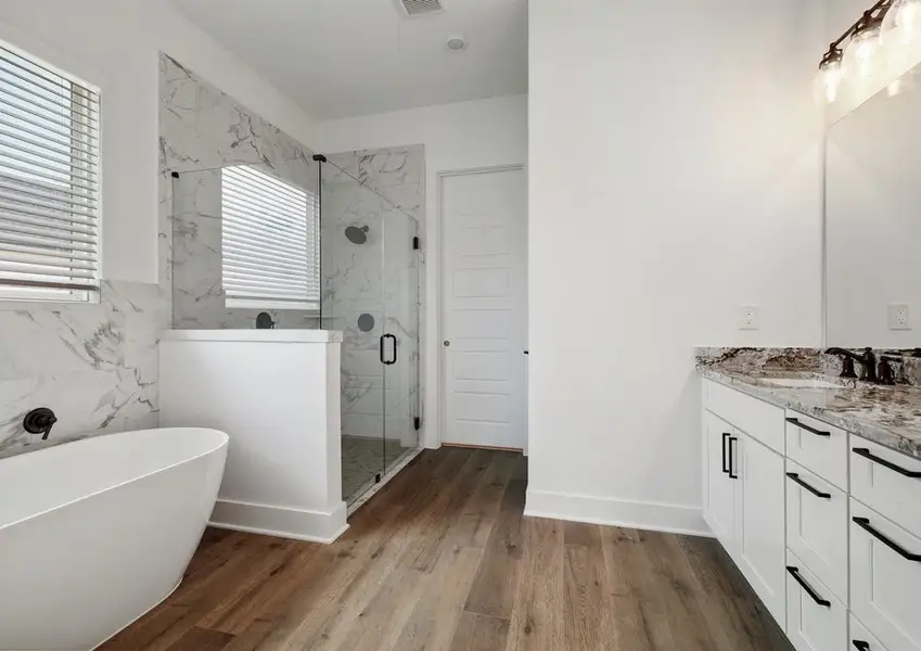 The spa-inspired primary bath with a walk-in shower and stadalone tub