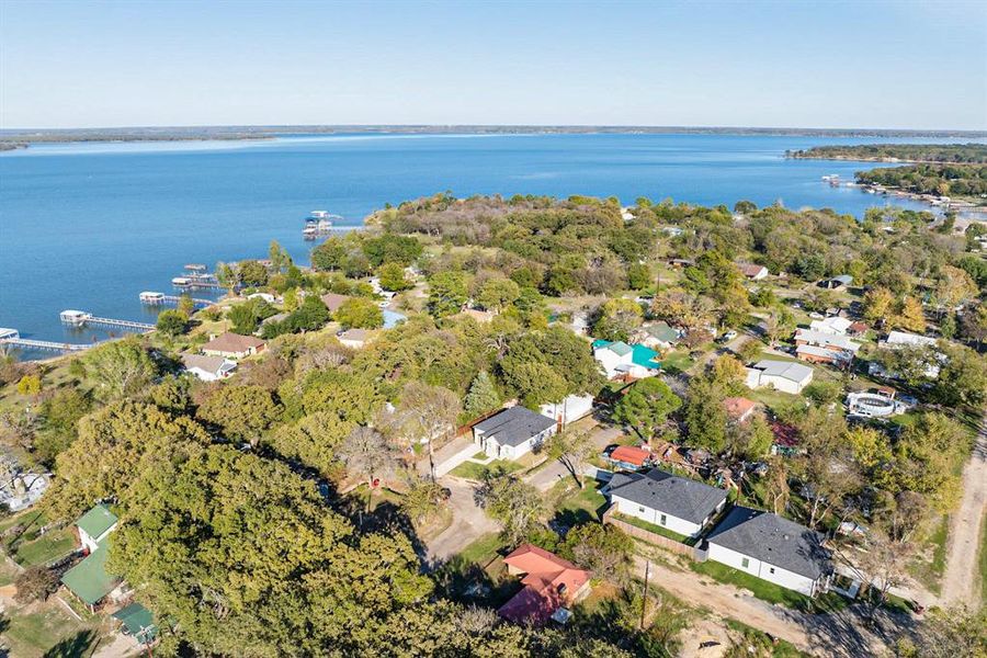 Birds eye view of property with a water view