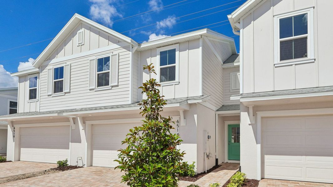 Front exterior of a new home in Cyrene at Harmony, St. Cloud, FL, highlighting curb appeal (Image 21). Front exterior of a new home in Cyrene at Harmony, St. Cloud, FL, highlighting curb appeal (Image 21).