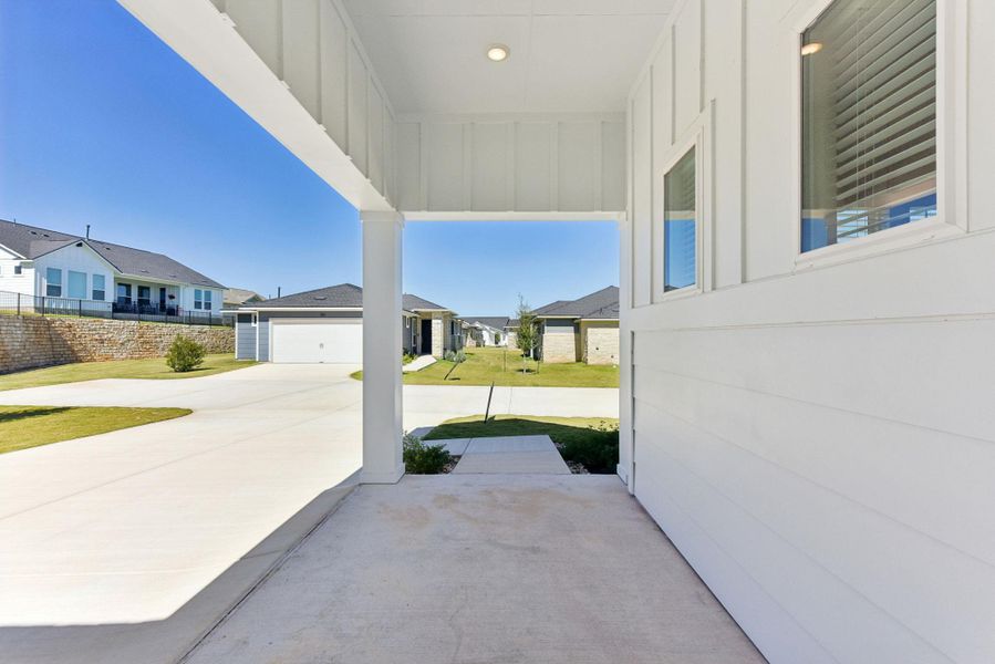 View of patio / terrace with a garage and concrete driveway