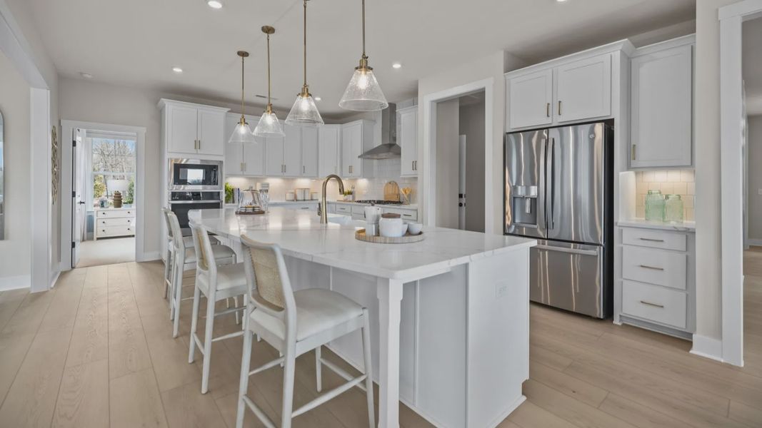 The Stonefield Home Plan by DRB Homes in Belmont, NC. - Kitchen featuring an oversized bar and butler's panty