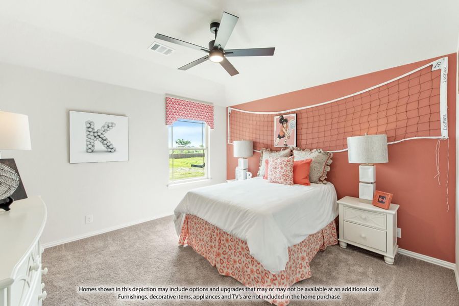 Bedroom with coral accent wall, ceiling fan, carpet flooring, and a queen bed with decorative pillows Bedroom with coral accent wall, ceiling fan, carpet flooring, and a queen bed with decorative pillows