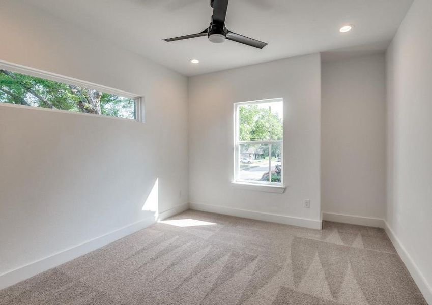 Carpeted empty room featuring ceiling fan