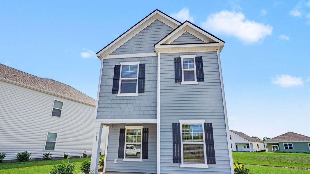 Front exterior of a new home in Fox Run, Supply, NC, highlighting curb appeal (Image 1). Front exterior of a new home in Fox Run, Supply, NC, highlighting curb appeal (Image 1).
