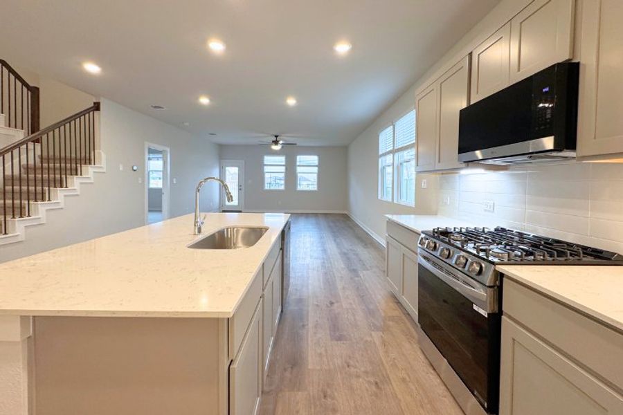 A kitchen with white cabinets.