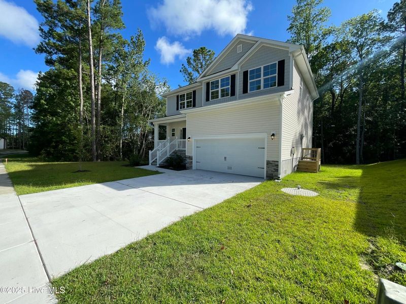Front exterior of a new home in Mill Creek Cove, Bolivia, NC, highlighting curb appeal (Image 15).