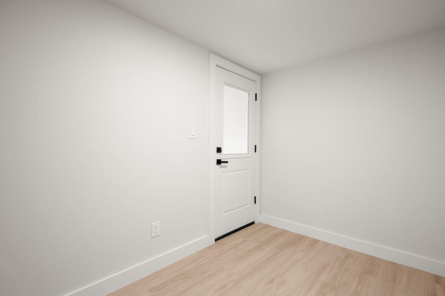 Empty room with baseboards and light wood finished floors