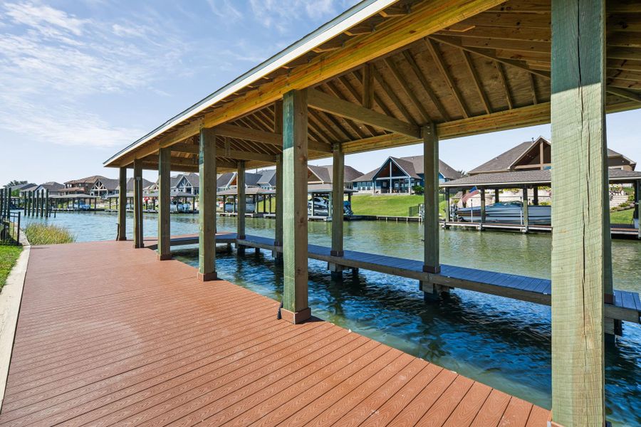 Private covered boat dock offering convenient water access and scenic views, perfect for boating, fishing, or enjoying life on the water.