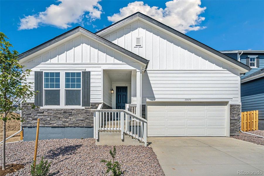 Front exterior of a new home in Turnberry, Commerce City, CO, highlighting curb appeal (Image 17).