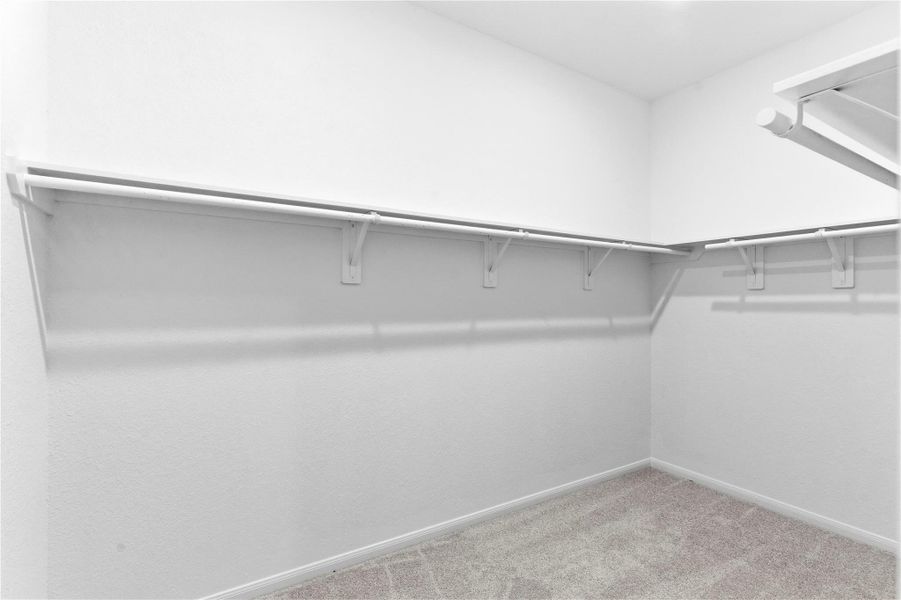 Spacious walk-in closet provides hanging space and storage, offering practical organization for daily living. Spacious walk-in closet provides hanging space and storage, offering practical organization for daily living.
