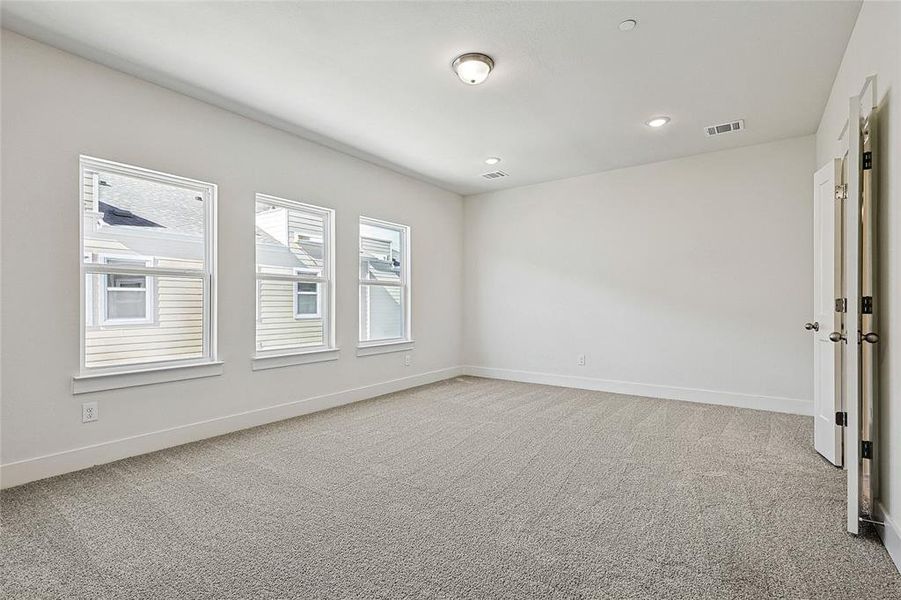 Spare room with light colored carpet and recessed lighting