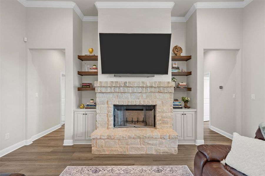 Living room anchored by a wood-burning fireplace and built-in cabinetry. Living room anchored by a wood-burning fireplace and built-in cabinetry.