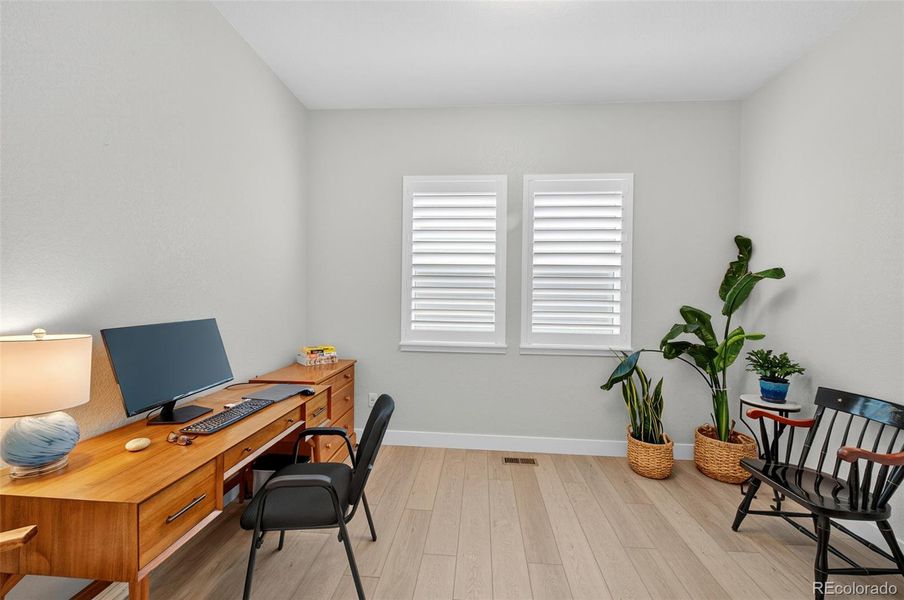 Home Office / Study – Versatile workspace or study with wood-look flooring, large windows, and plenty of room for desks or reading furniture.