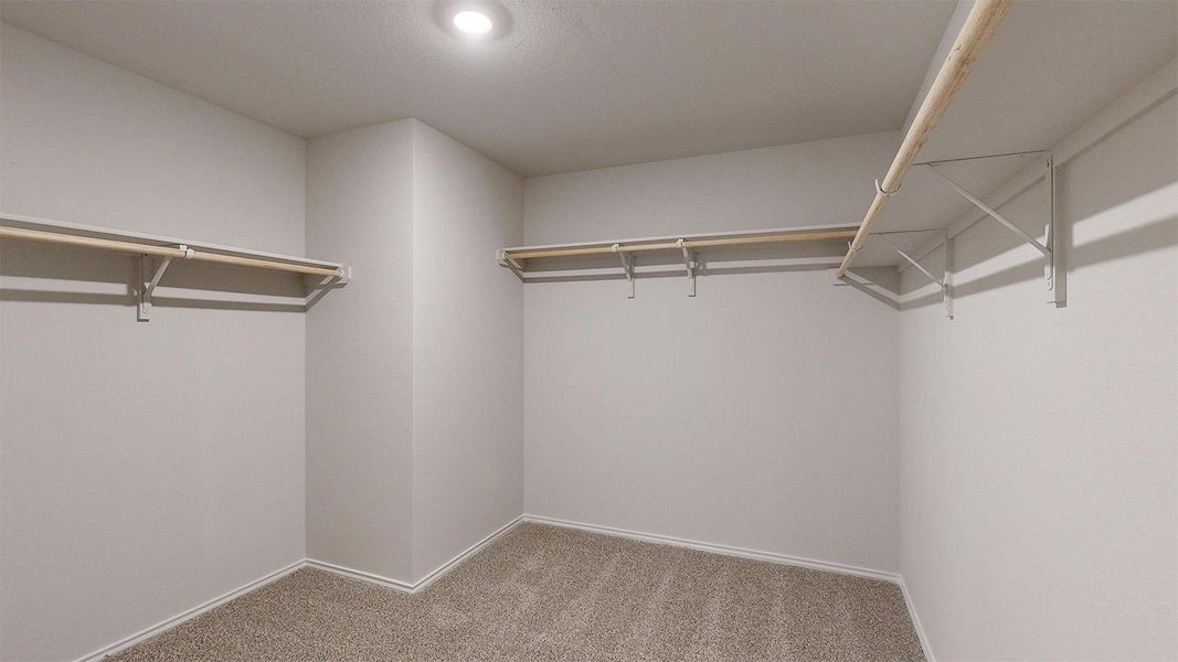 Ample closet space with practical shelving and hanging rods.