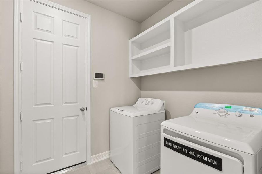 The laundry room layout is carefully planned for optimal workflow with designated areas for washing, drying, and storing.