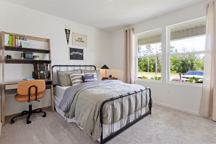 A bedroom with a bed and a chair. A bedroom with a bed and a chair.