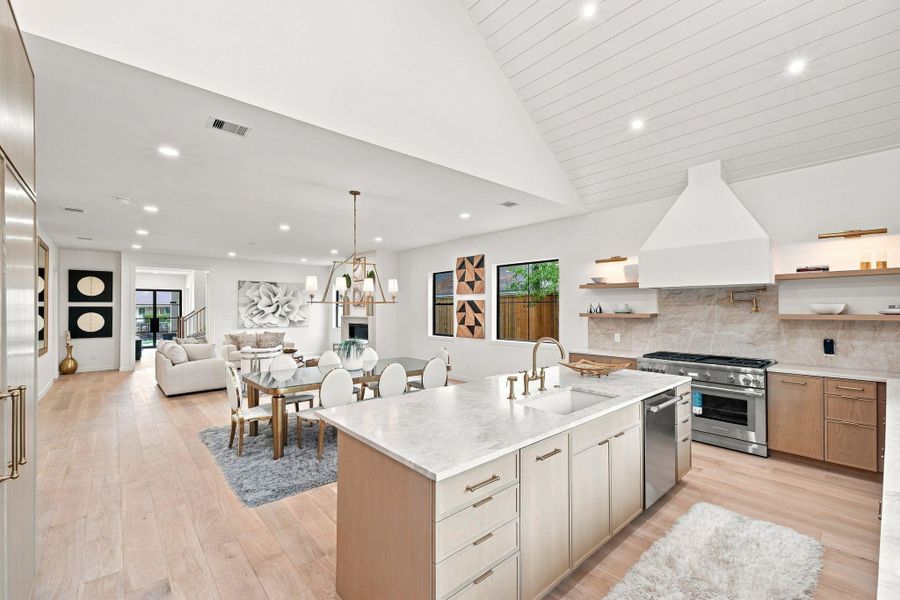 Kitchen with custom cabinets, Taj Mahal countertops, and Thermadore appliances.