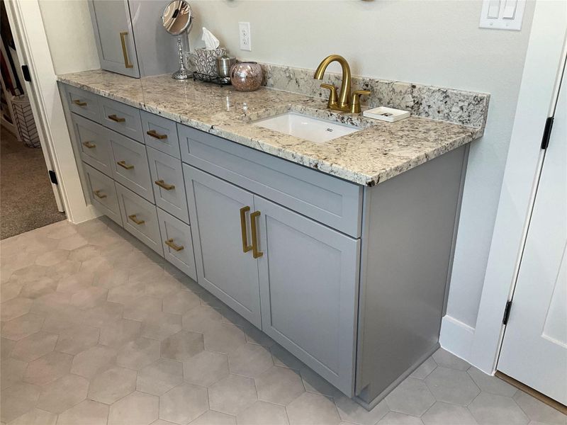 Dual vanities with undercount sinks, custom cabinets with drawers