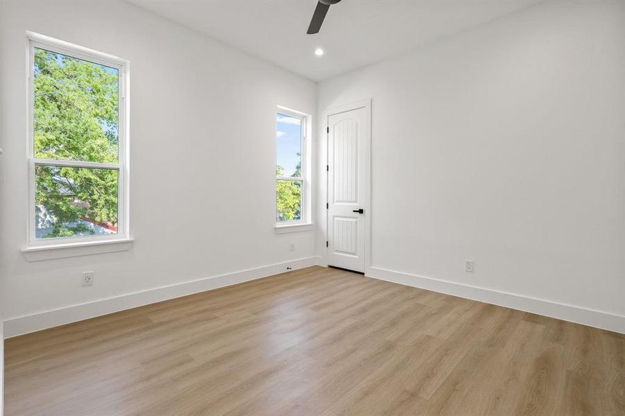 Spare room with ceiling fan and light hardwood / wood-style floors