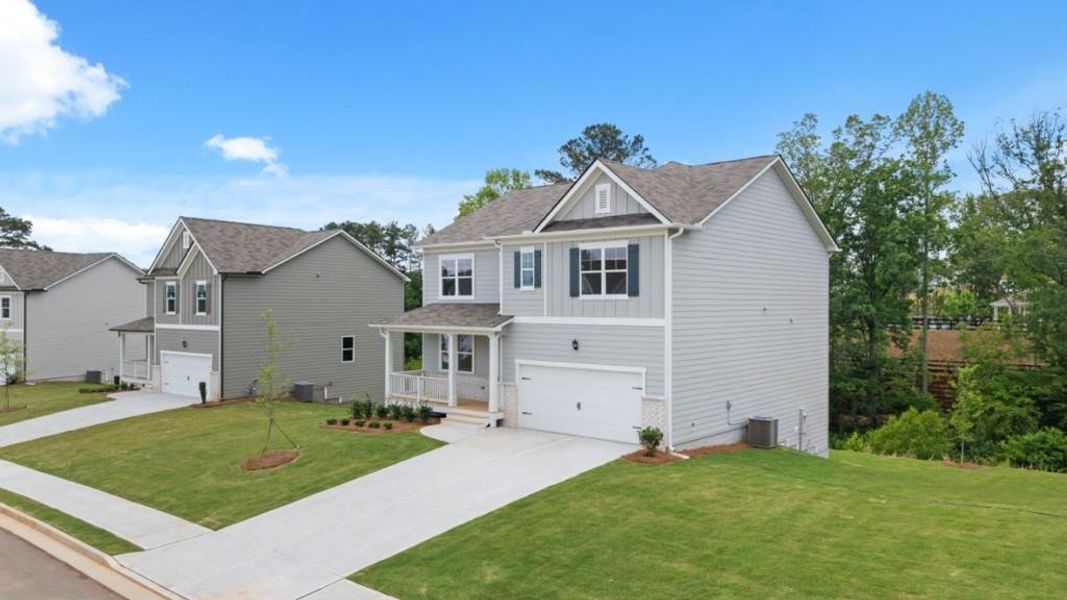 Front exterior of a new home in Thompson Ridge, Dallas, GA, highlighting curb appeal (Image 2). Front exterior of a new home in Thompson Ridge, Dallas, GA, highlighting curb appeal (Image 2).