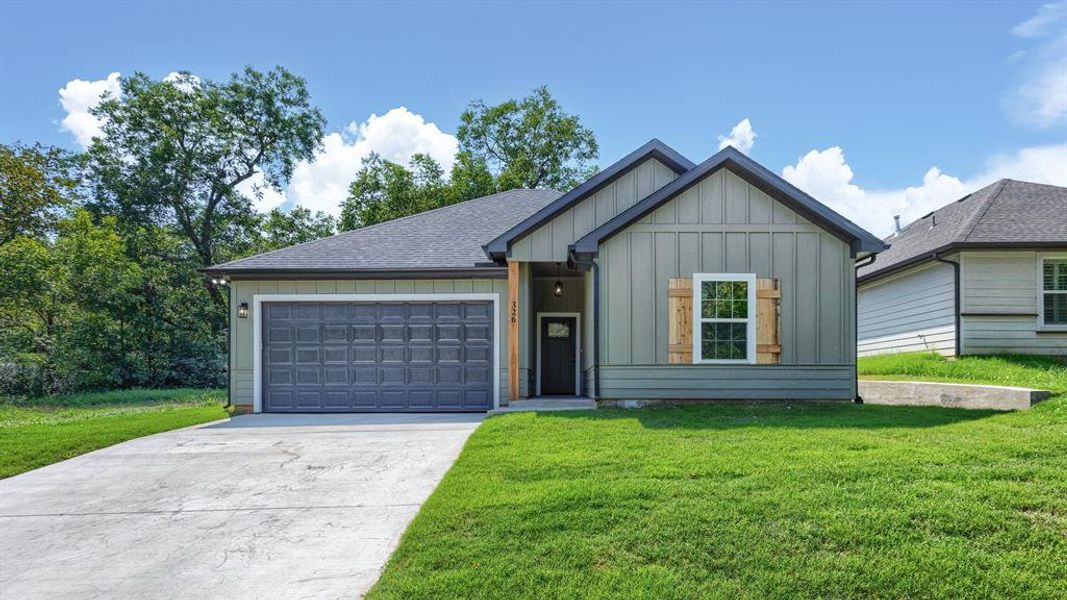 View of front of house featuring board and batten siding, concrete driveway, a front lawn, a garage, and a shingled roof View of front of house featuring board and batten siding, concrete driveway, a front lawn, a garage, and a shingled roof